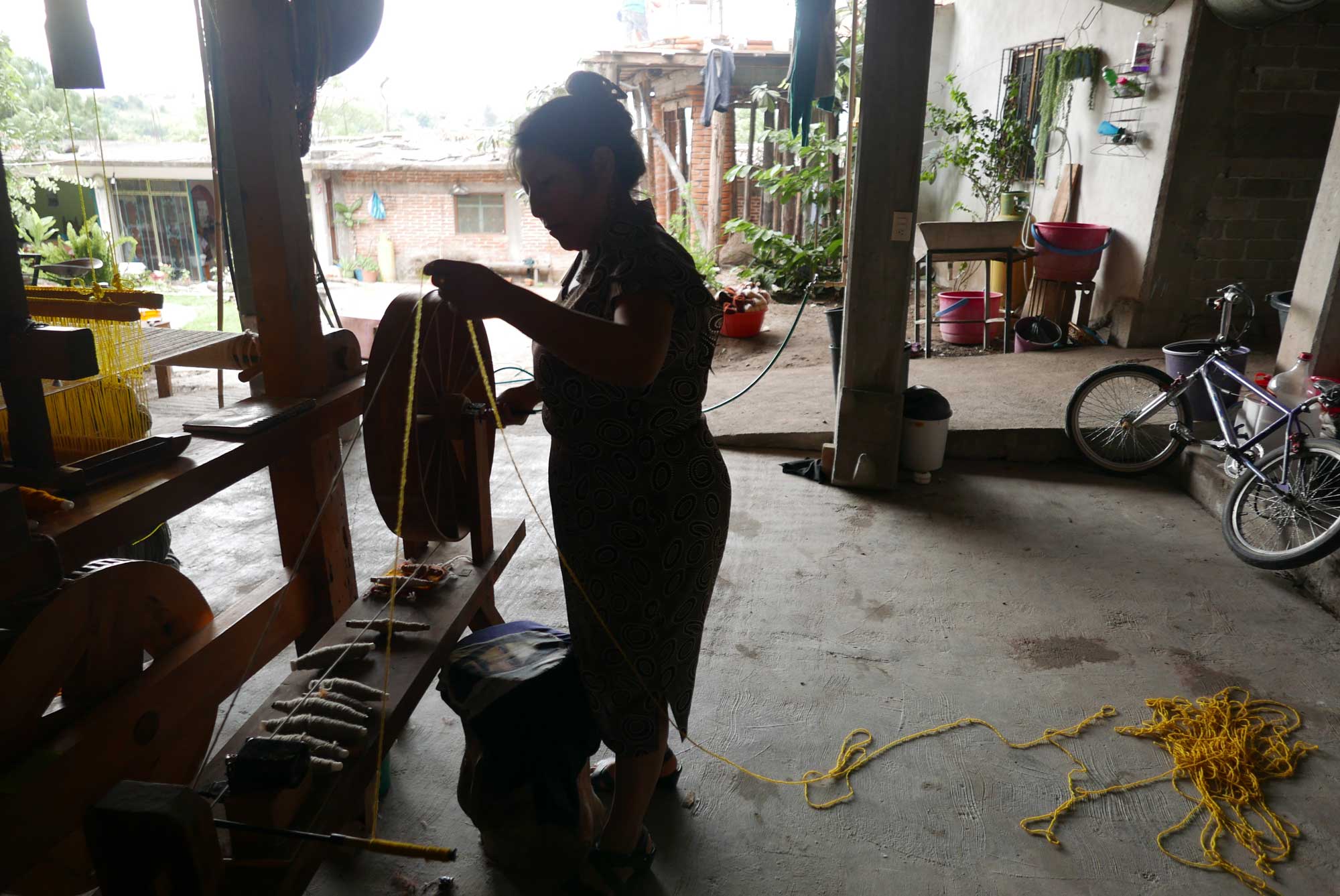 Artisan Spinning Wool for weaving Zapotec Rug Teotitlan de Valle Mexico